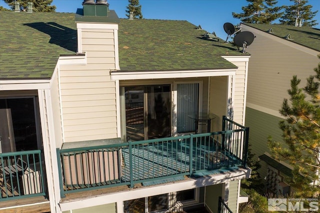 view of side of property with a balcony