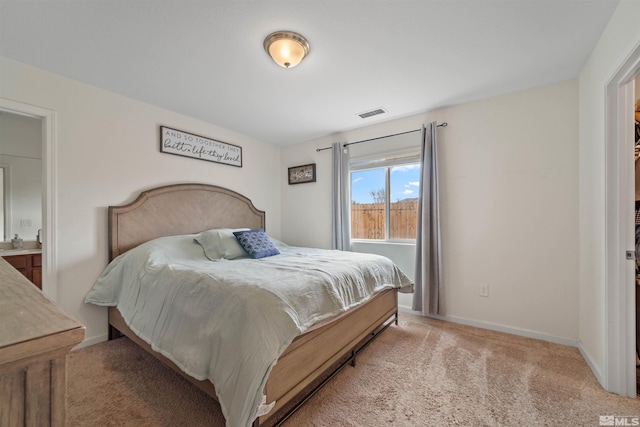 carpeted bedroom with connected bathroom