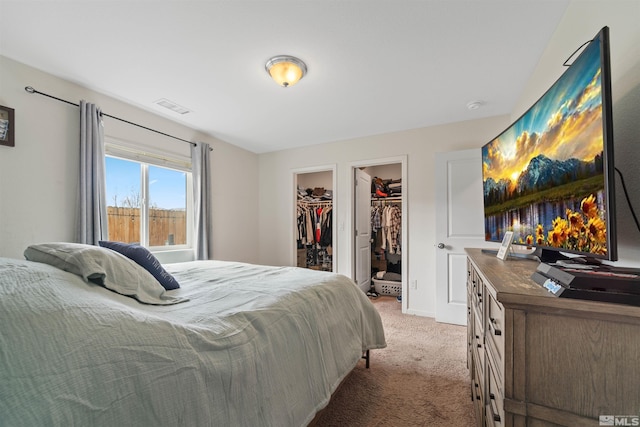 bedroom featuring carpet flooring, a spacious closet, and a closet