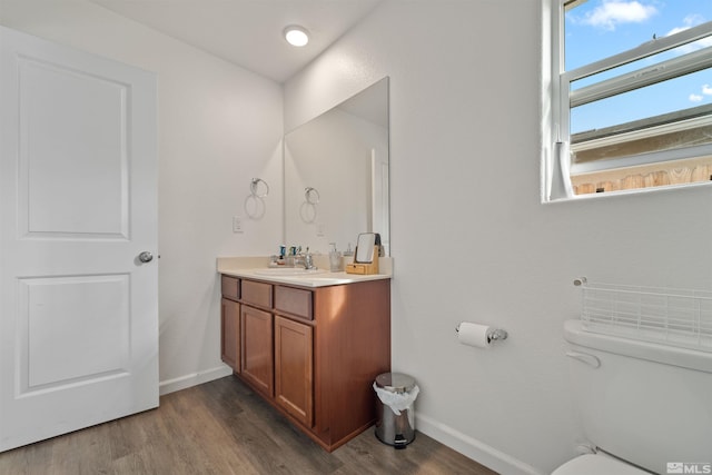 bathroom featuring hardwood / wood-style floors, vanity, and toilet