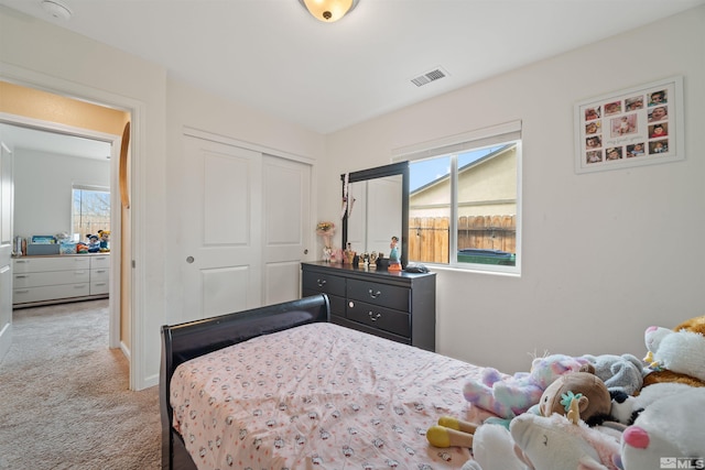 carpeted bedroom featuring a closet