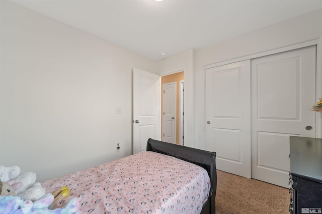 bedroom with carpet and a closet