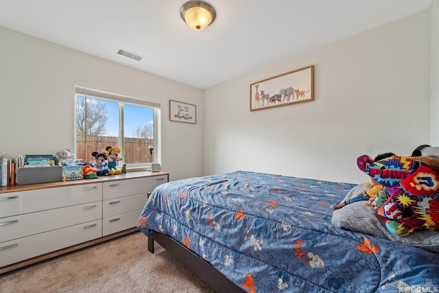 bedroom featuring light carpet