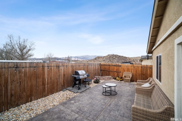 view of patio / terrace featuring area for grilling and a mountain view