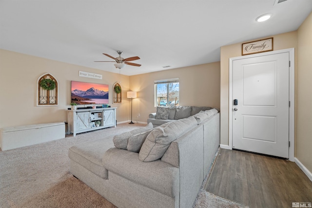 living room featuring ceiling fan and wood-type flooring