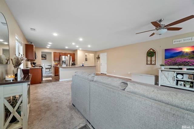 living room with carpet floors and ceiling fan