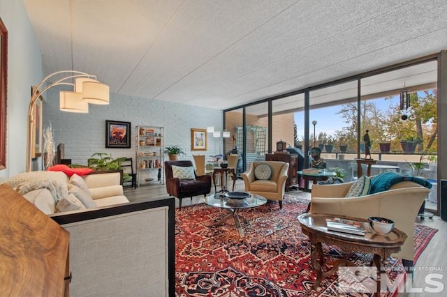 living room featuring hardwood / wood-style flooring and a wall of windows