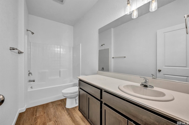 full bathroom featuring vanity, toilet, wood-type flooring, and bathtub / shower combination