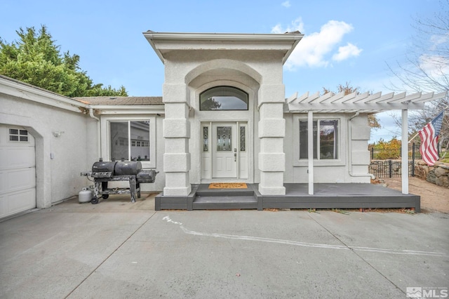 entrance to property with a deck and a garage