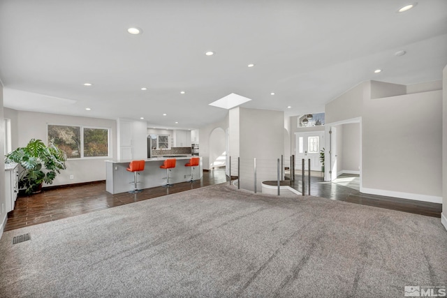 unfurnished living room with dark wood-type flooring