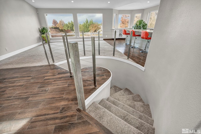 stairway with hardwood / wood-style floors