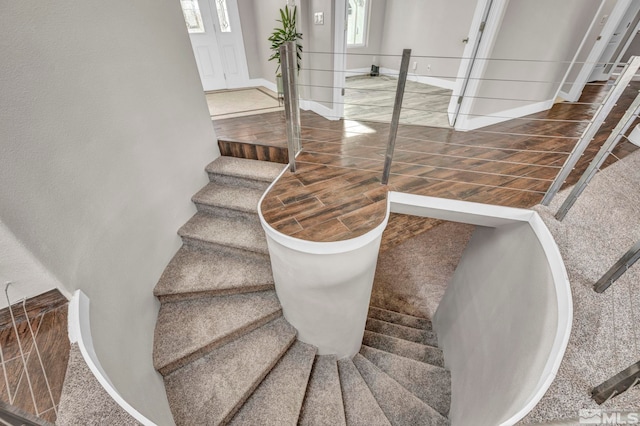 stairway featuring carpet