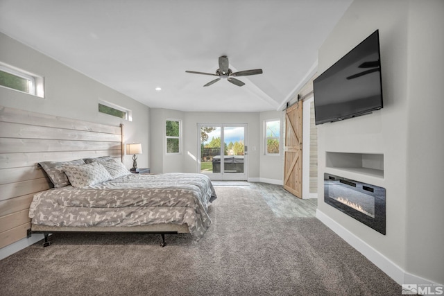 carpeted bedroom featuring access to outside, a barn door, and ceiling fan