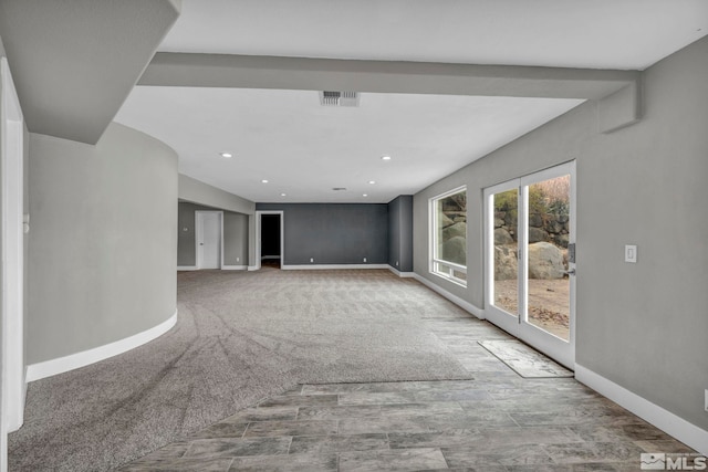 unfurnished living room featuring carpet floors