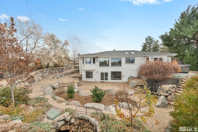 rear view of property featuring a patio area