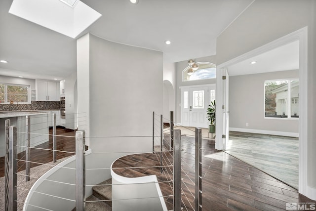 entryway with dark hardwood / wood-style flooring and sink