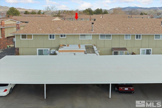 exterior space with a mountain view and a carport