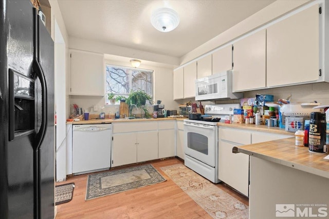 kitchen with white cabinetry, light wood-type flooring, white appliances, and sink