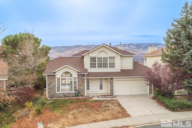 view of front property featuring a mountain view and a garage