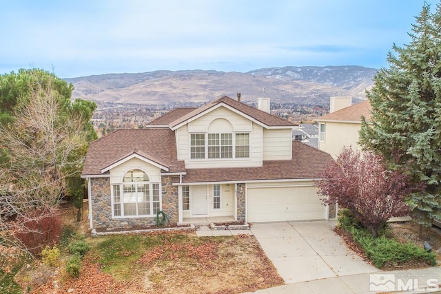 front facade featuring a mountain view and a garage