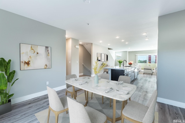 dining area with hardwood / wood-style floors and sink