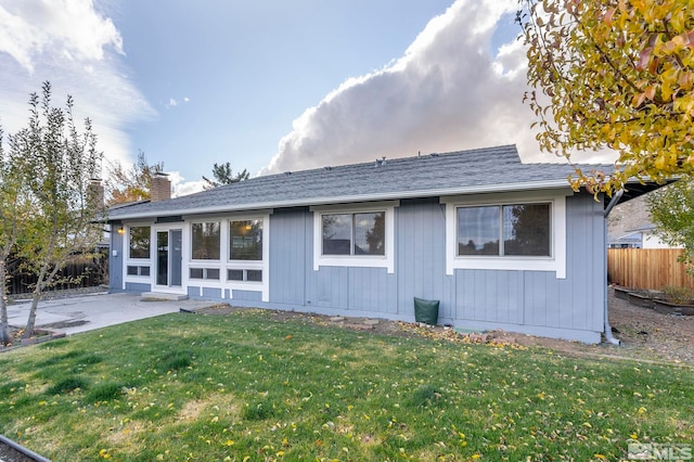 back of property featuring a yard and a patio area