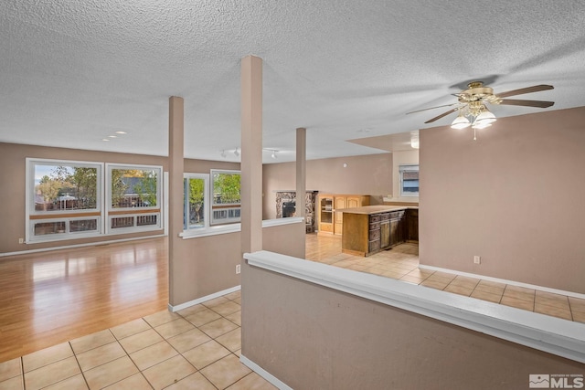 kitchen featuring a textured ceiling, light hardwood / wood-style flooring, and ceiling fan