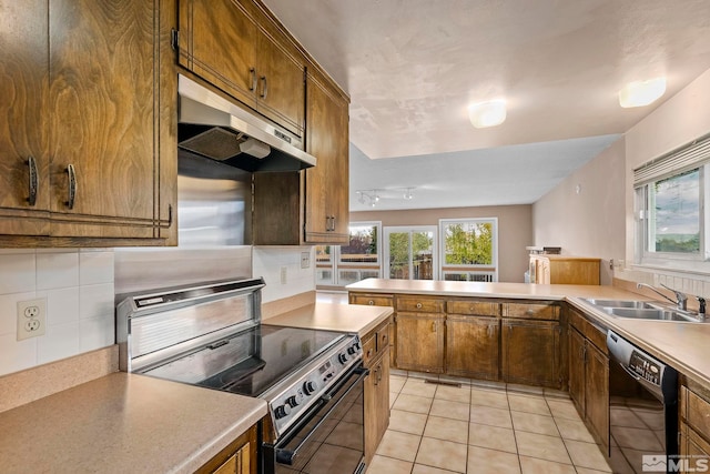 kitchen featuring kitchen peninsula, tasteful backsplash, sink, black appliances, and light tile patterned flooring