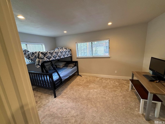 carpeted bedroom with multiple windows