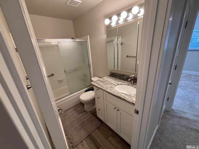 full bathroom featuring vanity, toilet, and enclosed tub / shower combo