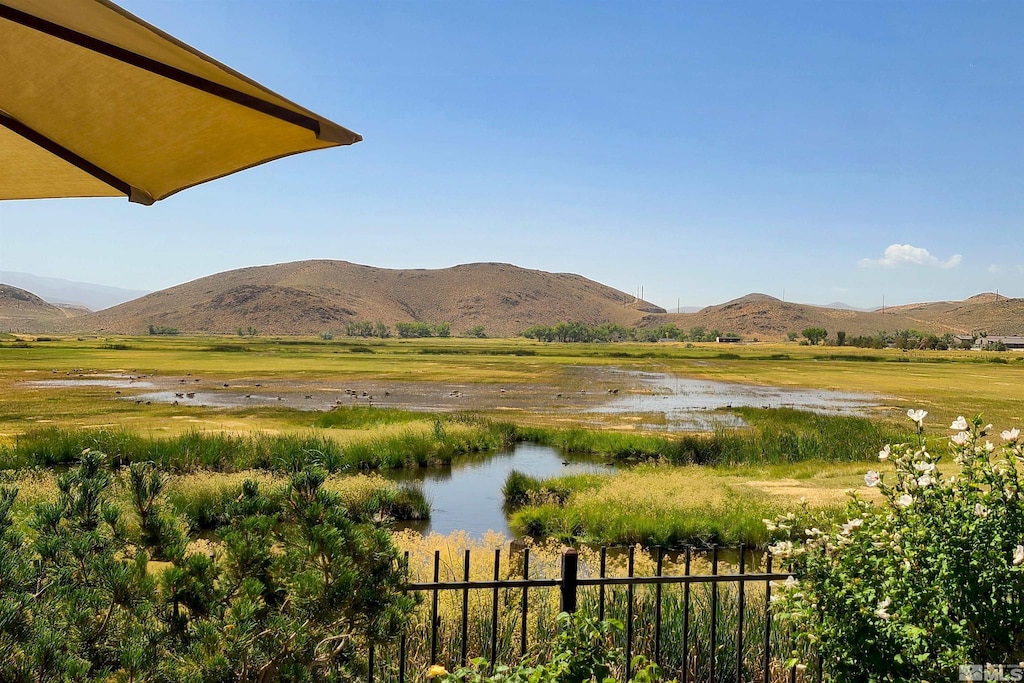 property view of mountains featuring a rural view and a water view