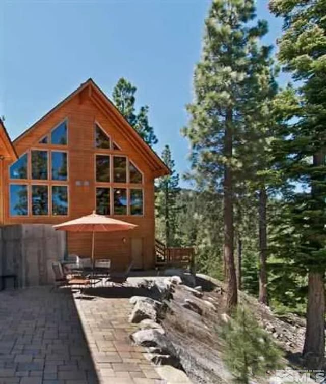 rear view of property featuring a patio area