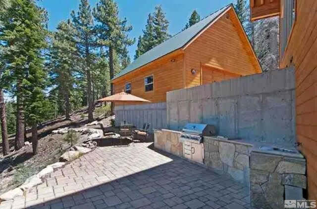 view of patio featuring area for grilling and an outdoor kitchen