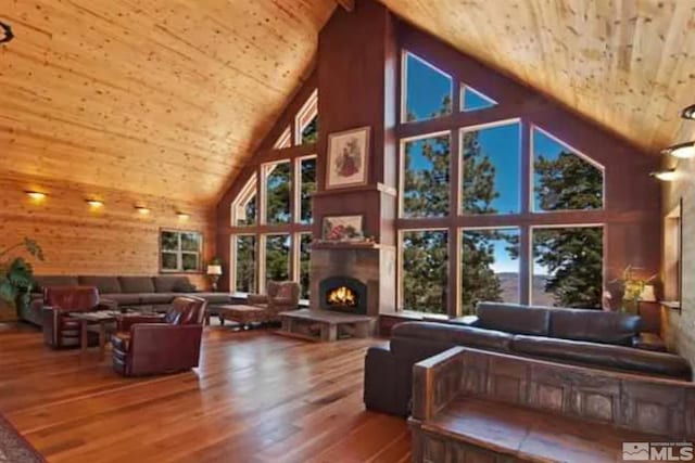 living room with hardwood / wood-style flooring, high vaulted ceiling, wood walls, and wood ceiling