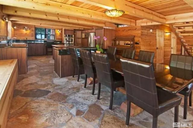 dining room with wood walls and wood ceiling