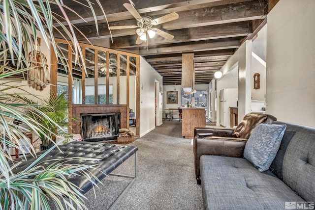 carpeted living room with beamed ceiling, ceiling fan, and a fireplace