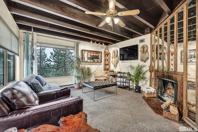 carpeted living room featuring beamed ceiling and ceiling fan