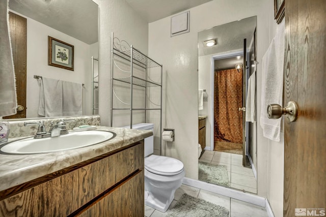 bathroom featuring tile patterned flooring, vanity, and toilet