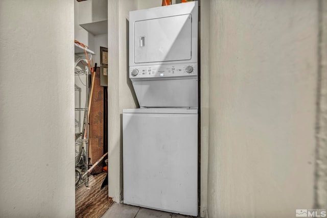 laundry area with stacked washer and clothes dryer