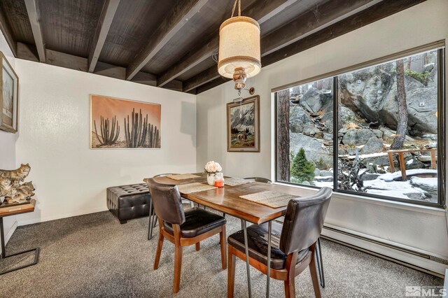 carpeted dining room featuring beam ceiling, a baseboard radiator, and a healthy amount of sunlight