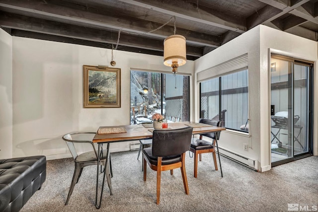 carpeted dining space with beam ceiling and a baseboard heating unit