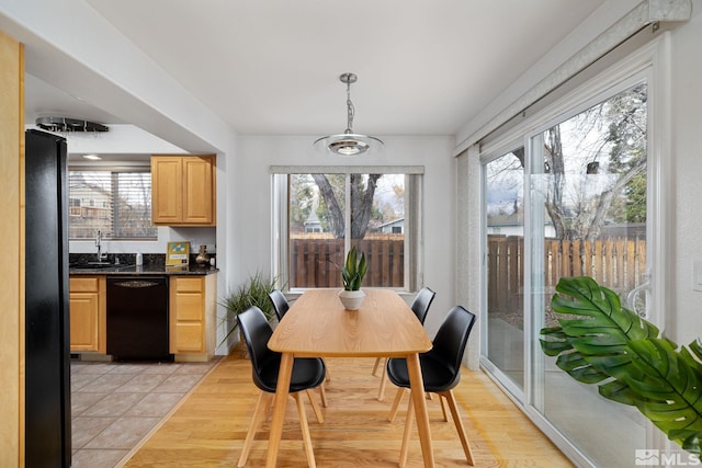 dining area featuring light hardwood / wood-style flooring and sink