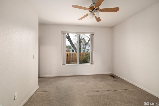 carpeted spare room featuring ceiling fan