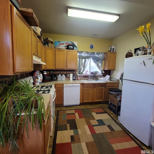 kitchen featuring white appliances and sink