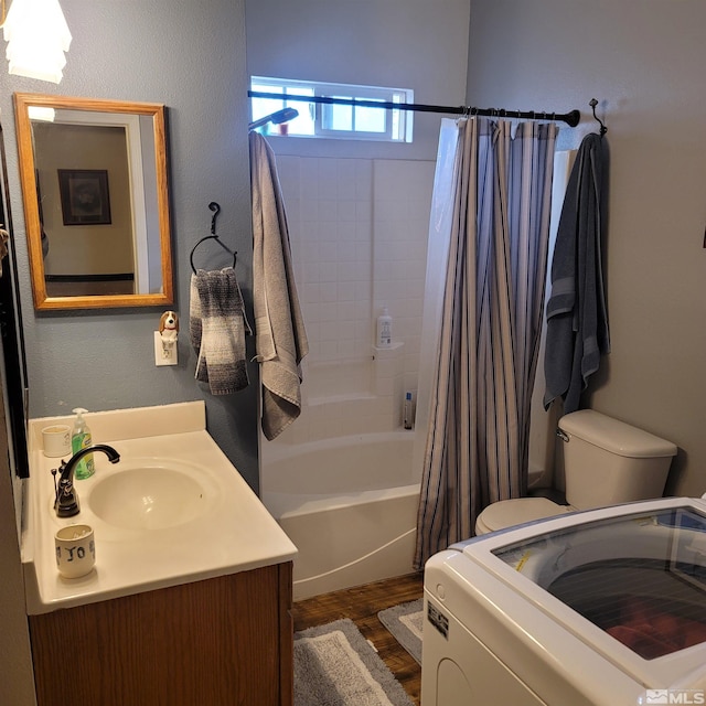 full bathroom with toilet, washer / dryer, shower / bath combo with shower curtain, and vanity