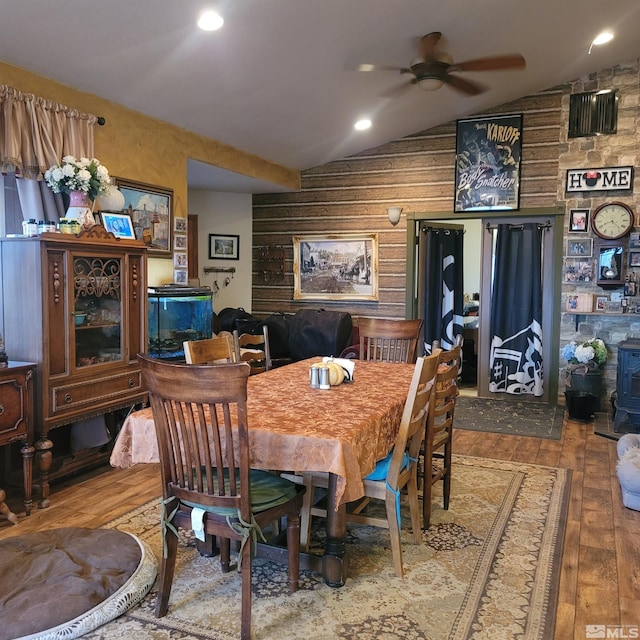 dining space with ceiling fan, wood-type flooring, and lofted ceiling