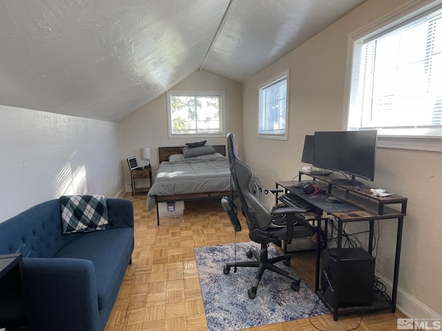 bedroom featuring lofted ceiling and light parquet floors