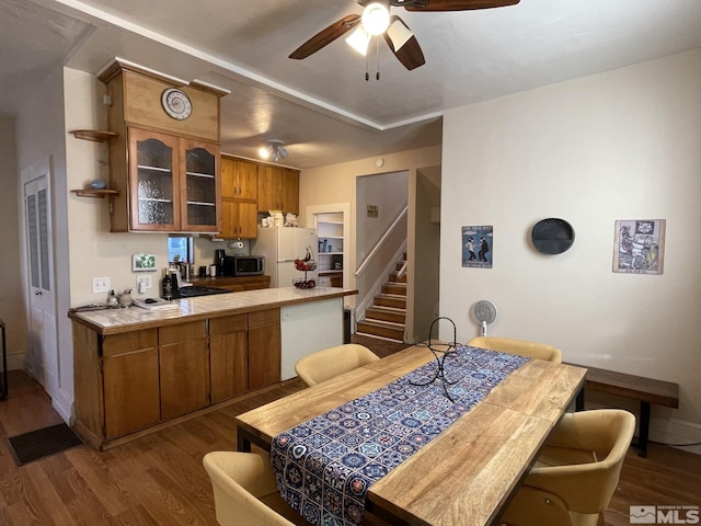 kitchen featuring tile countertops, ceiling fan, dark hardwood / wood-style flooring, and white fridge