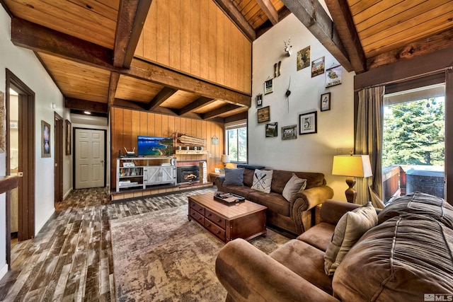 living room featuring wooden ceiling, a brick fireplace, lofted ceiling with beams, wood walls, and hardwood / wood-style floors