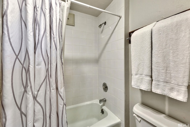 bathroom featuring toilet and shower / bathtub combination with curtain